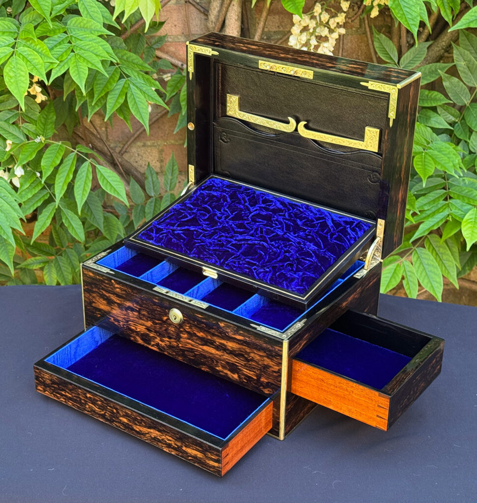 Front right interior view of an antique jewellery box in coromandel with front & side drawer, with both drawers opened and the mirror panel removed.