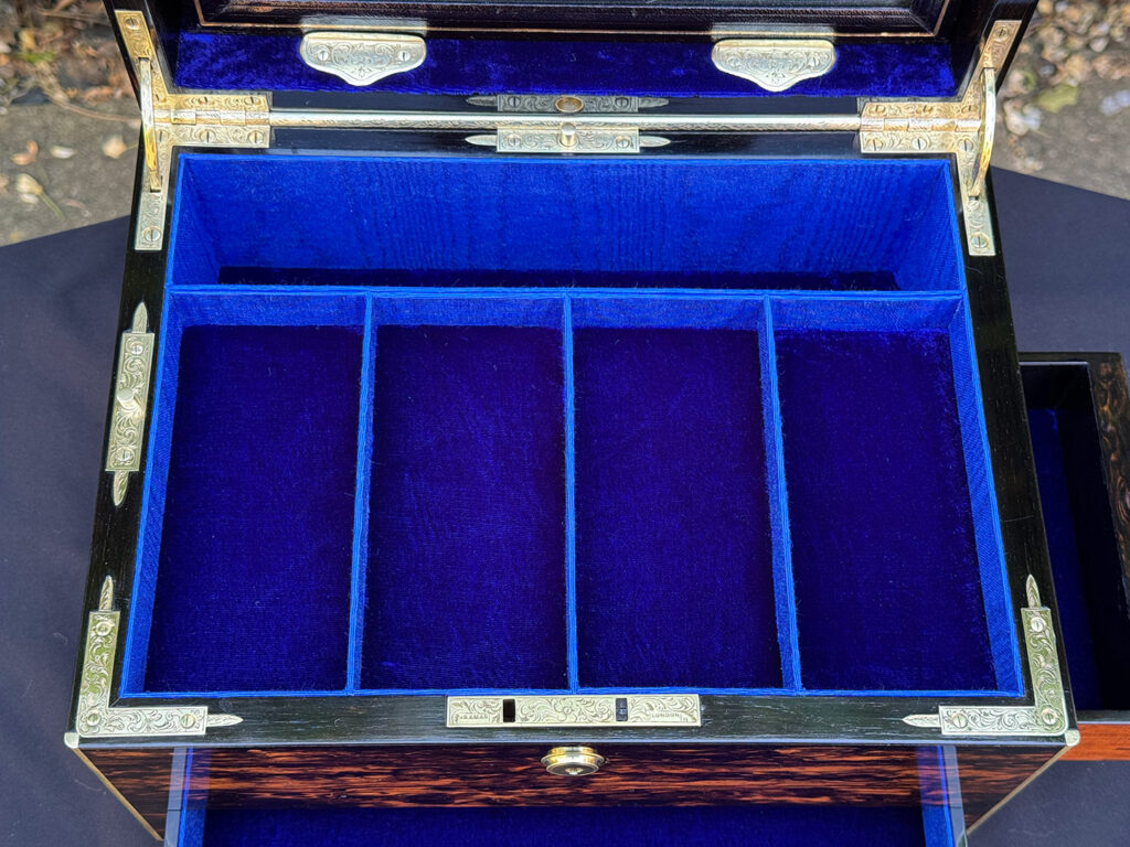 Overhead interior view of an antique jewellery box in coromandel with front & side drawer.