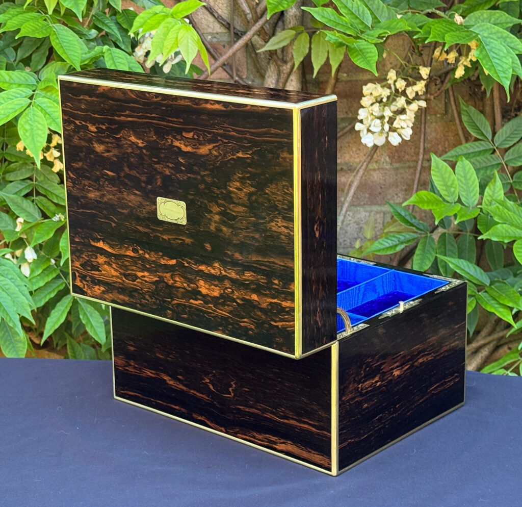 Rear opened view of an antique jewellery box in coromandel with front & side drawer.