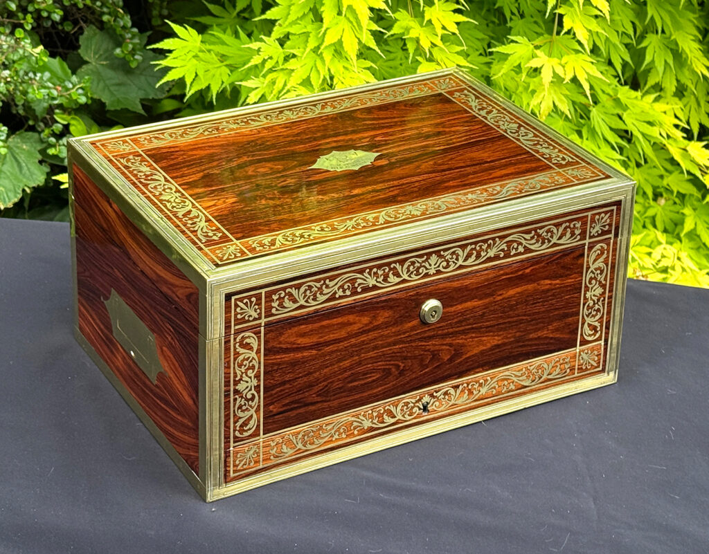 Front left view of an antique jewellery box in kingwood, by Wells & Lambe.
