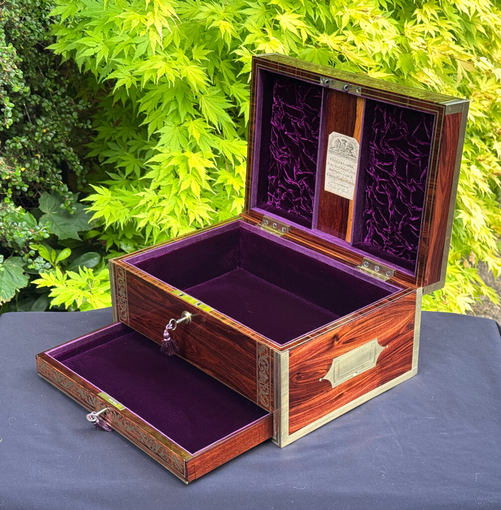 Front right interior view of an antique jewellery box in kingwood, by Wells & Lambe, with lower drawer opened.