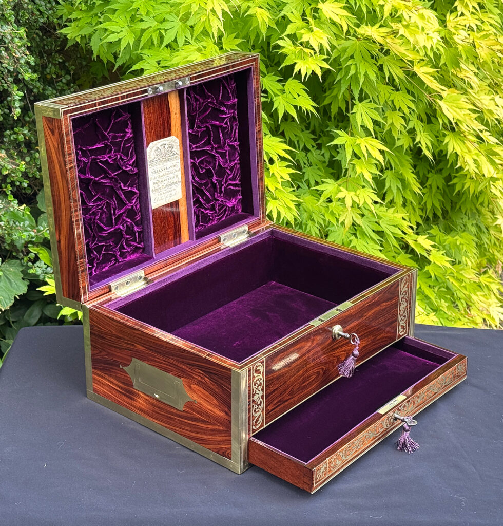 Front left interior view of an antique jewellery box in kingwood, by Wells & Lambe, with lower drawer opened.