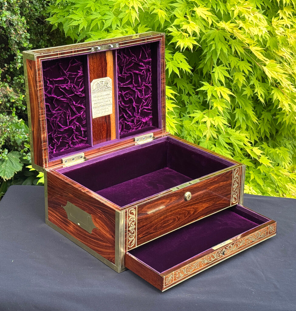 Front left interior view of an antique jewellery box in kingwood, by Wells & Lambe, with lower drawer opened.