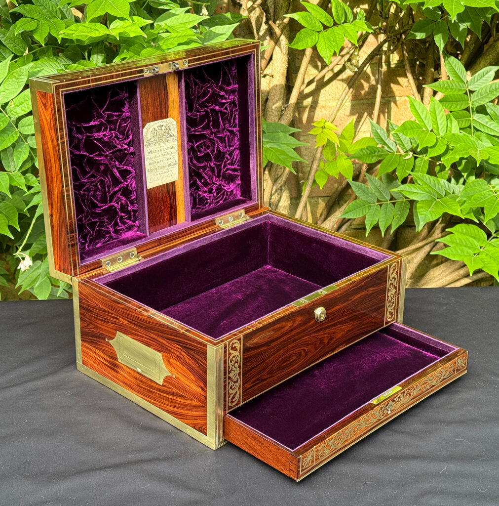 Front left interior view of an antique jewellery box in kingwood, by Wells & Lambe, with lower drawer opened.