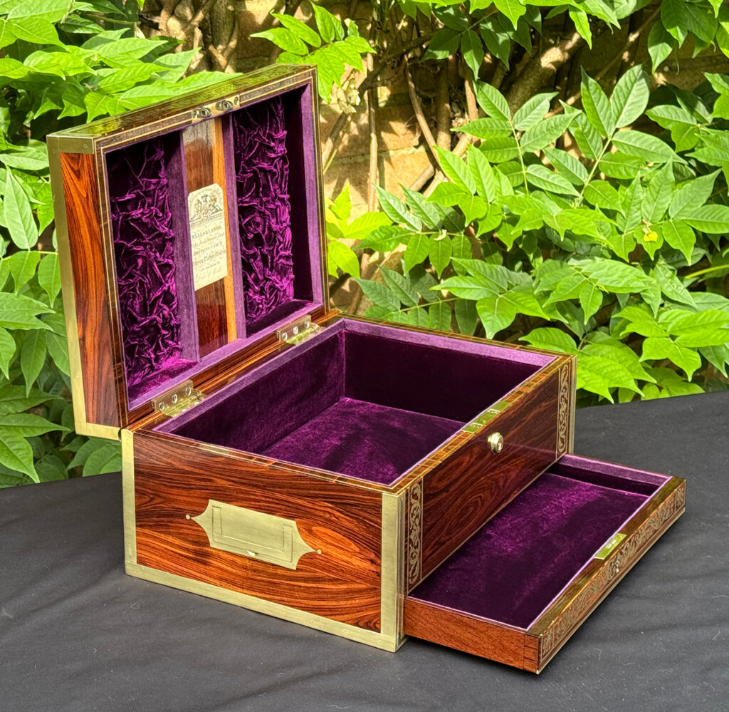 Front left interior view of an antique jewellery box in kingwood, by Wells & Lambe, with lower drawer opened.