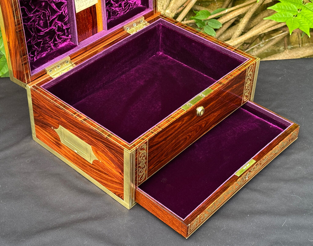 Closer interior view of an antique jewellery box in kingwood, by Wells & Lambe, with lower drawer opened.
