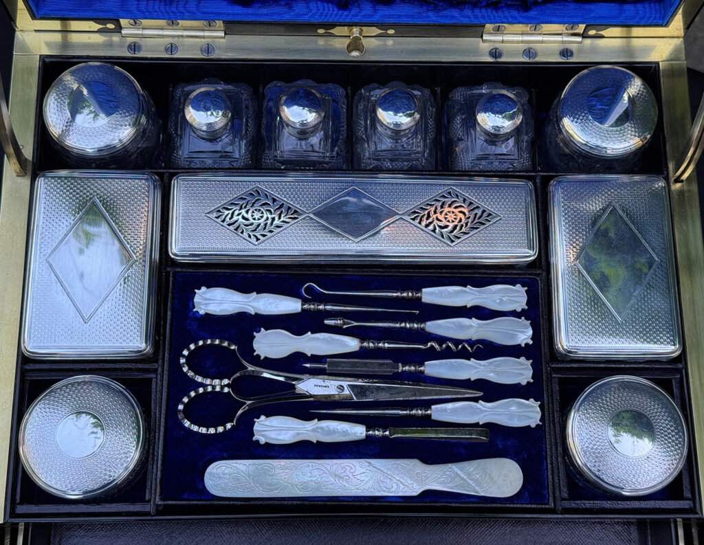 Closeup of the silver mounted bottles and vanity tools from a magnificent antique 1814 dressing case in rosewood by David Edwards.