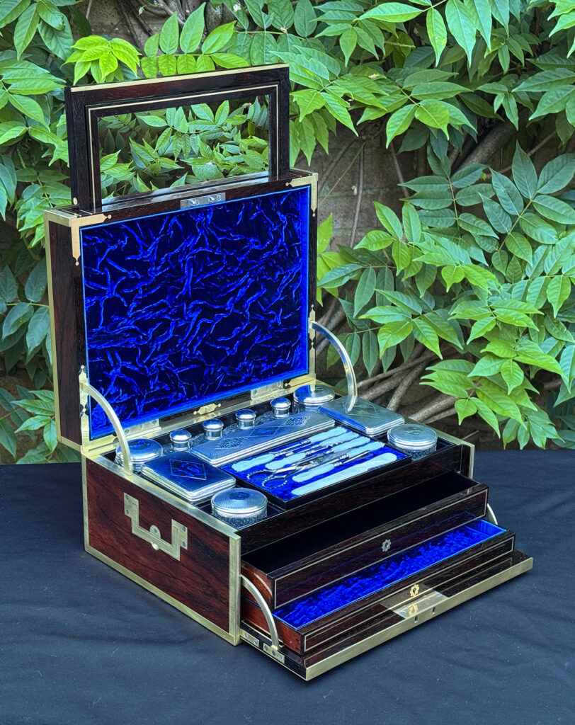Front left interior view of a magnificent antique 1814 dressing case in rosewood by David Edwards, with the mirror panel semi-deployed.
