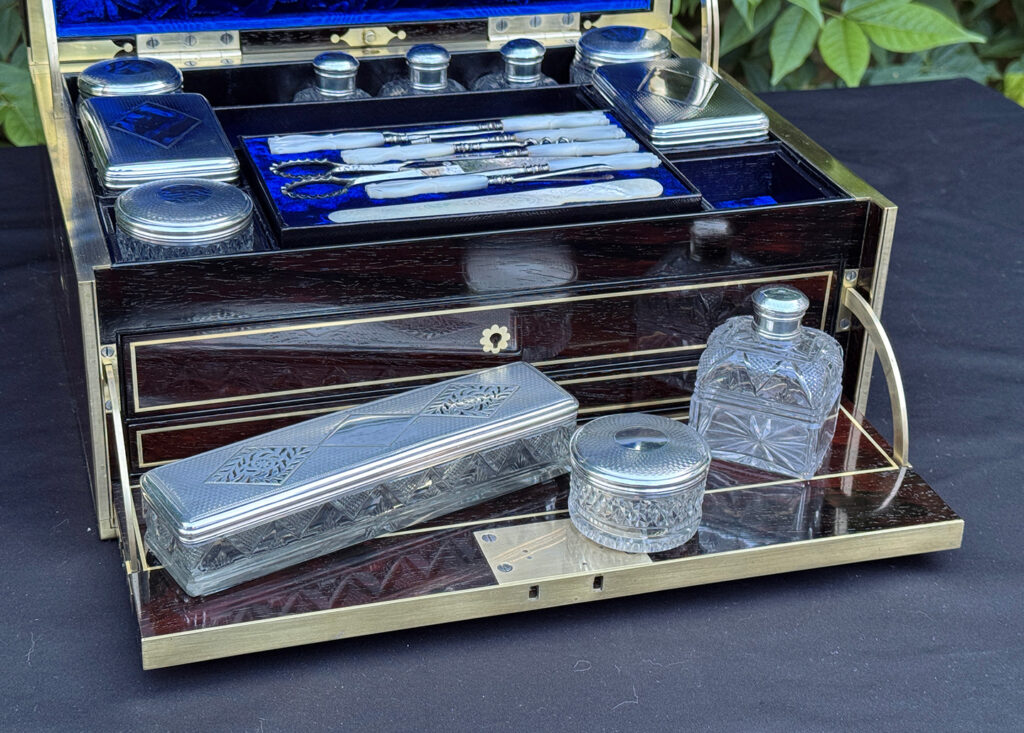 Closer view of the silver mounted, cut glass vanity bottles and jars from a magnificent antique 1814 dressing case in rosewood by David Edwards.