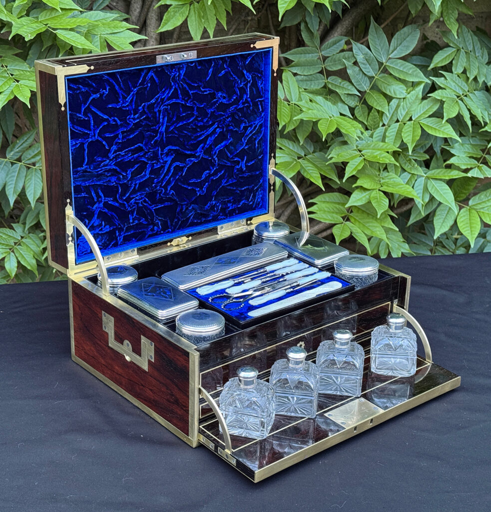 Front left view of the silver mounted, cut glass perfume bottles from a magnificent antique 1814 dressing case in rosewood by David Edwards.