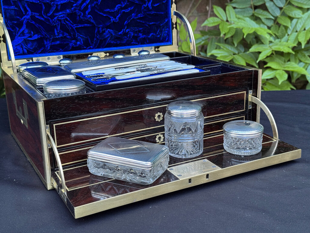 Closer view of the silver mounted, cut glass vanity bottles and jars from a magnificent antique 1814 dressing case in rosewood by David Edwards.