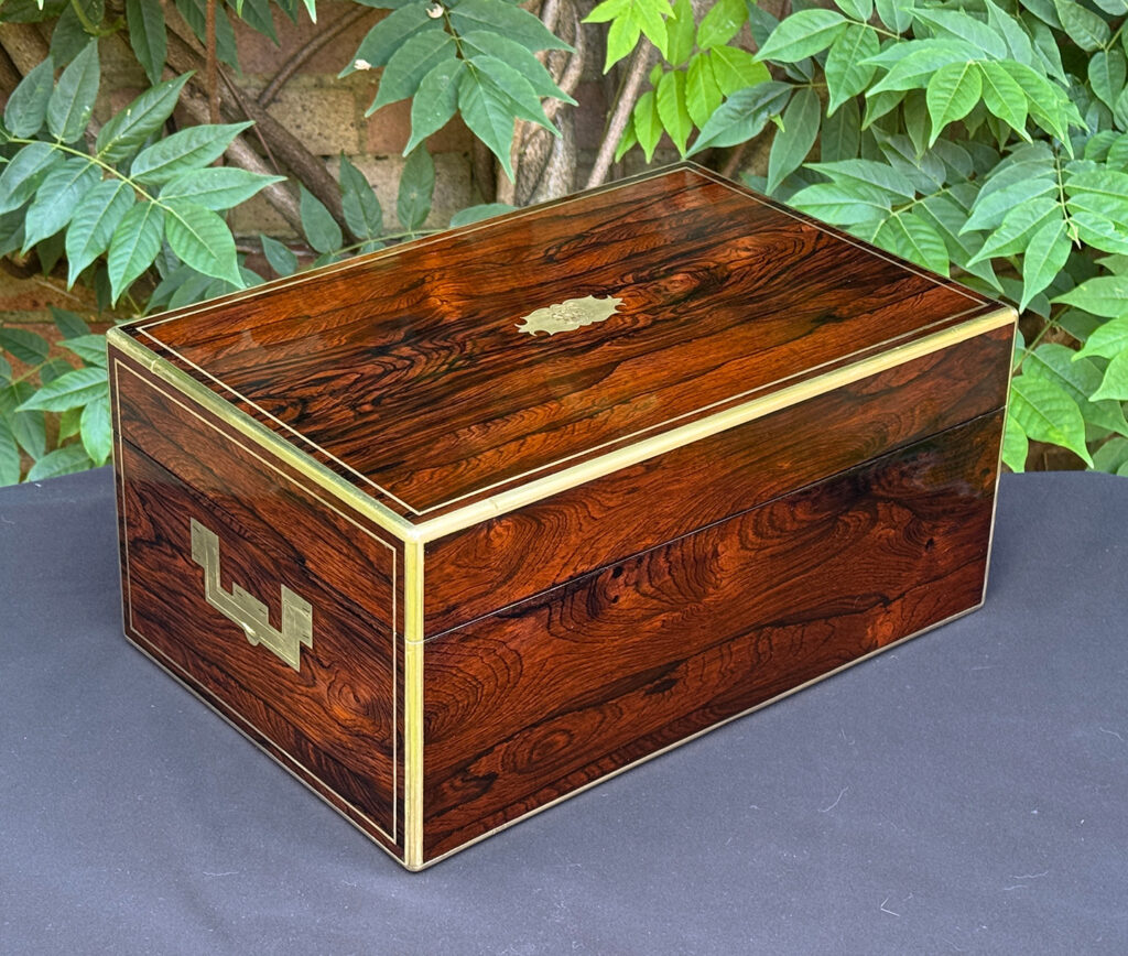 Rear right view of an antique document box in rosewood with satinwood interior, by Leuchars.