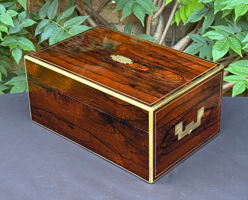 Rear left view of an antique document box in rosewood with satinwood interior, by Leuchars.
