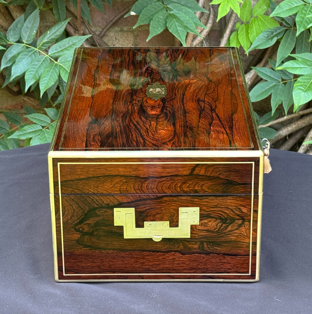 Left side view of an antique document box in rosewood with satinwood interior, by Leuchars.