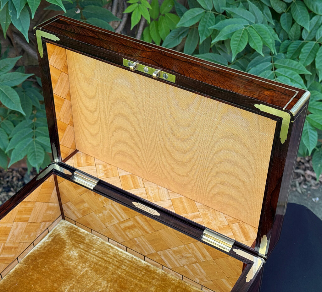 Closer view of the gold moiré silk lining in the lid of an antique document box in rosewood with satinwood interior, by Leuchars.