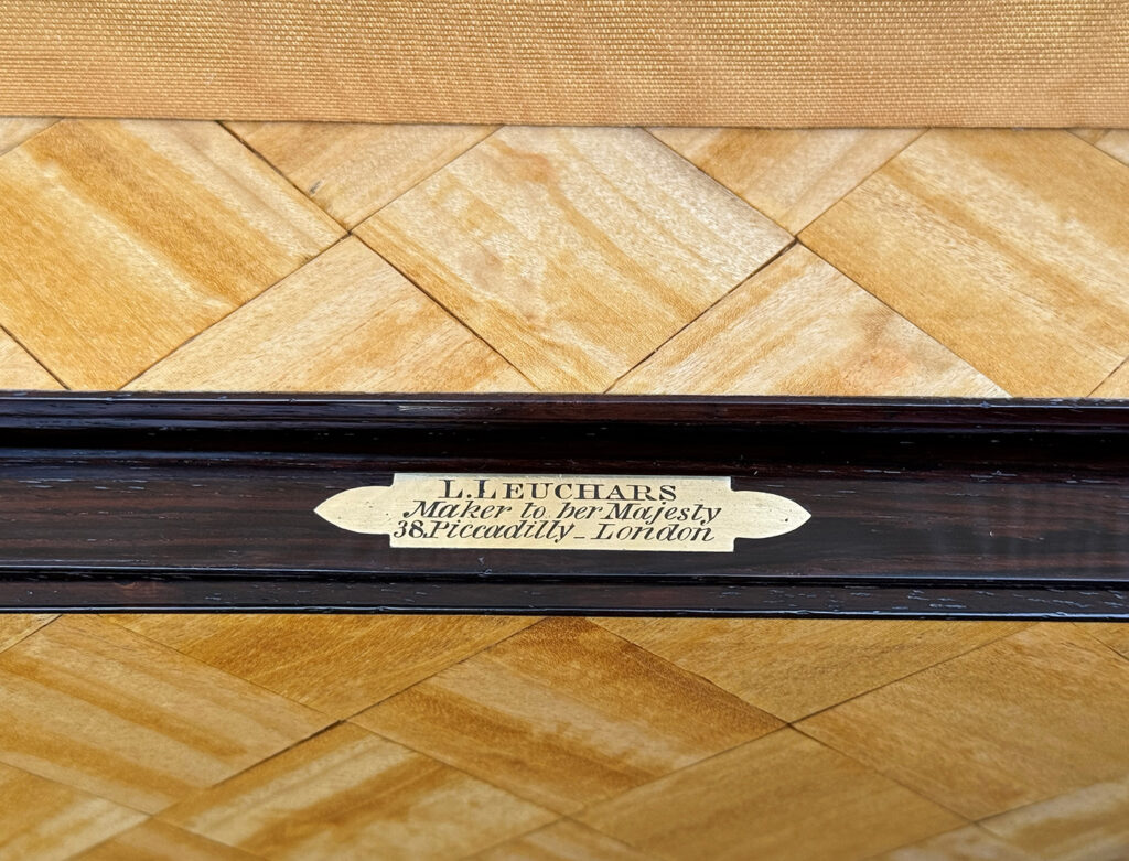 Close up view of the engraved brass maker's plate belonging to Lucy Leuchars.