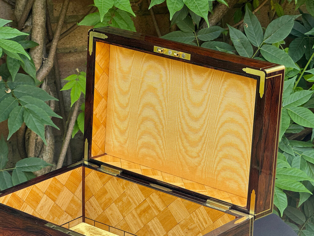 Gold moiré silk lining in the lid of an antique document box in rosewood with satinwood interior, by Leuchars.