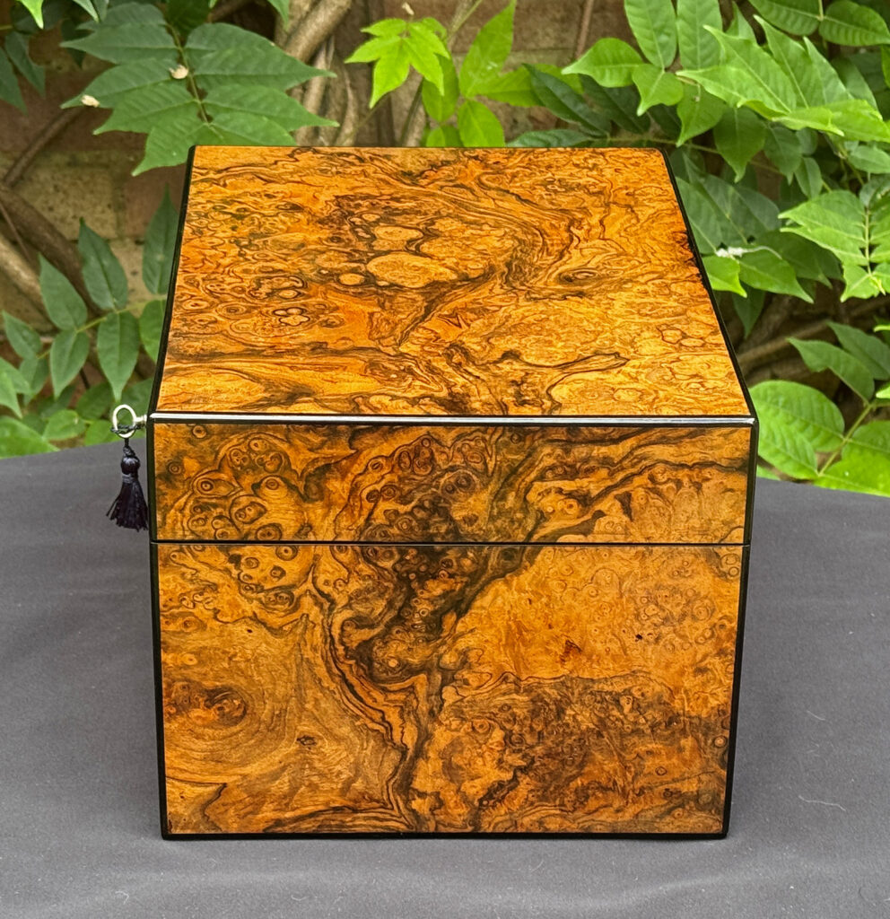 Right side view of an antique jewellery box in burr walnut, by George Betjemann & Sons.