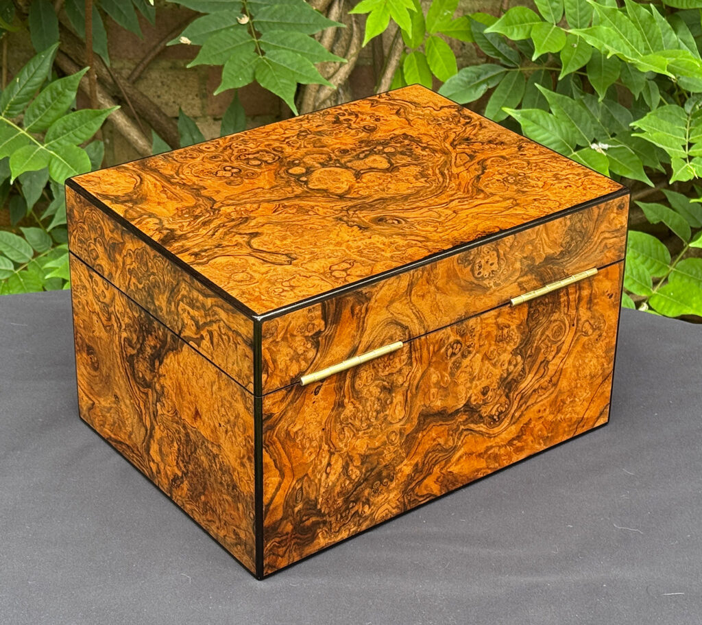Rear right view of an antique jewellery box in burr walnut, by George Betjemann & Sons.