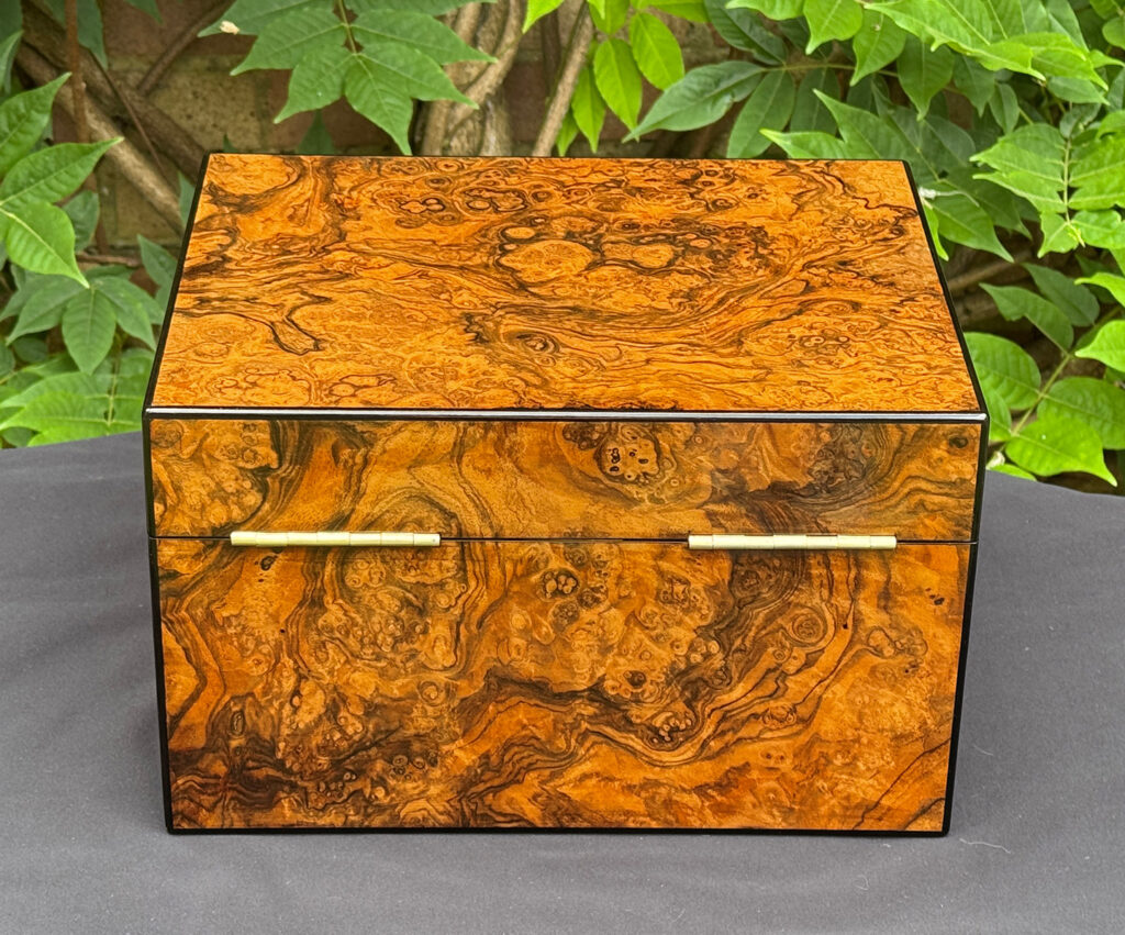Rear view of an antique jewellery box in burr walnut, by George Betjemann & Sons.