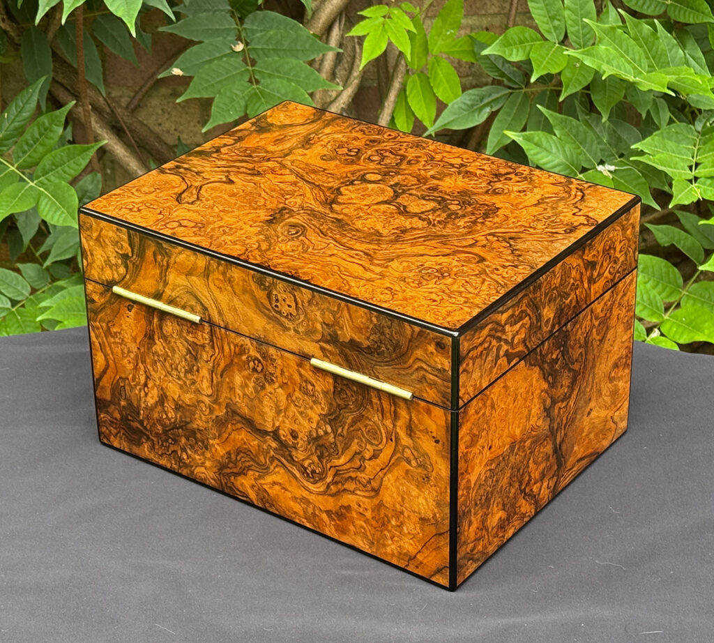 Rear left view of an antique jewellery box in burr walnut, by George Betjemann & Sons.