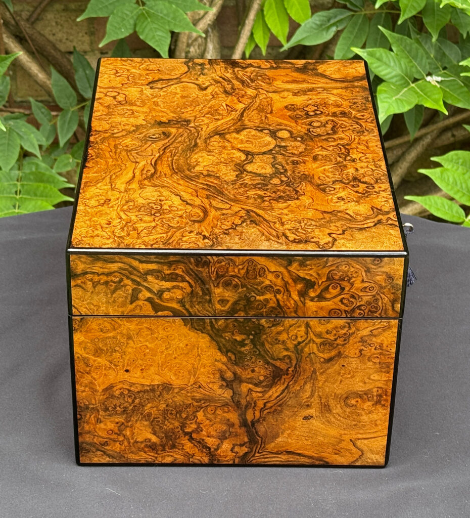 Left side view of an antique jewellery box in burr walnut, by George Betjemann & Sons.