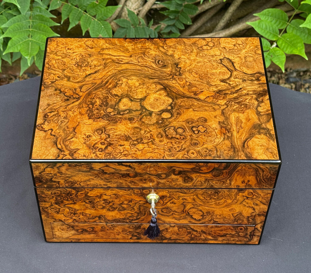 Overhead view of an antique jewellery box in burr walnut, by George Betjemann & Sons.