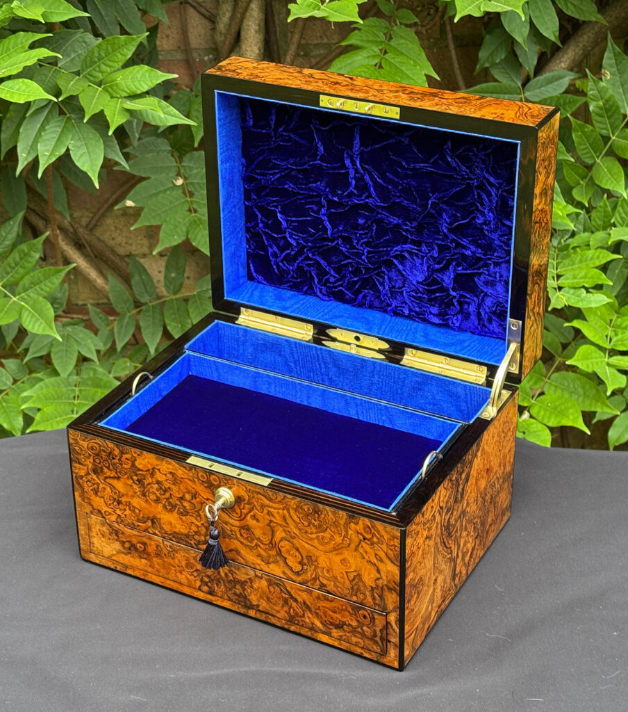 Front right interior view of an antique jewellery box in burr walnut, by George Betjemann & Sons.