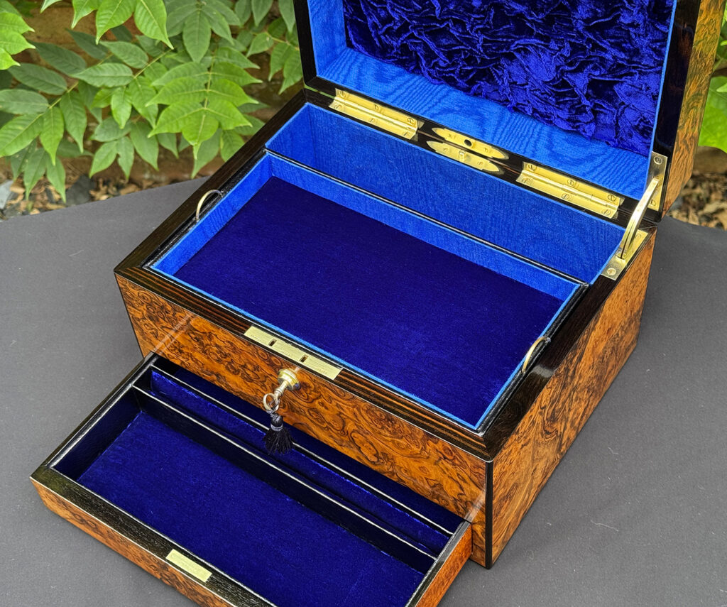 Closer interior view of an antique jewellery box in burr walnut, by George Betjemann & Sons.