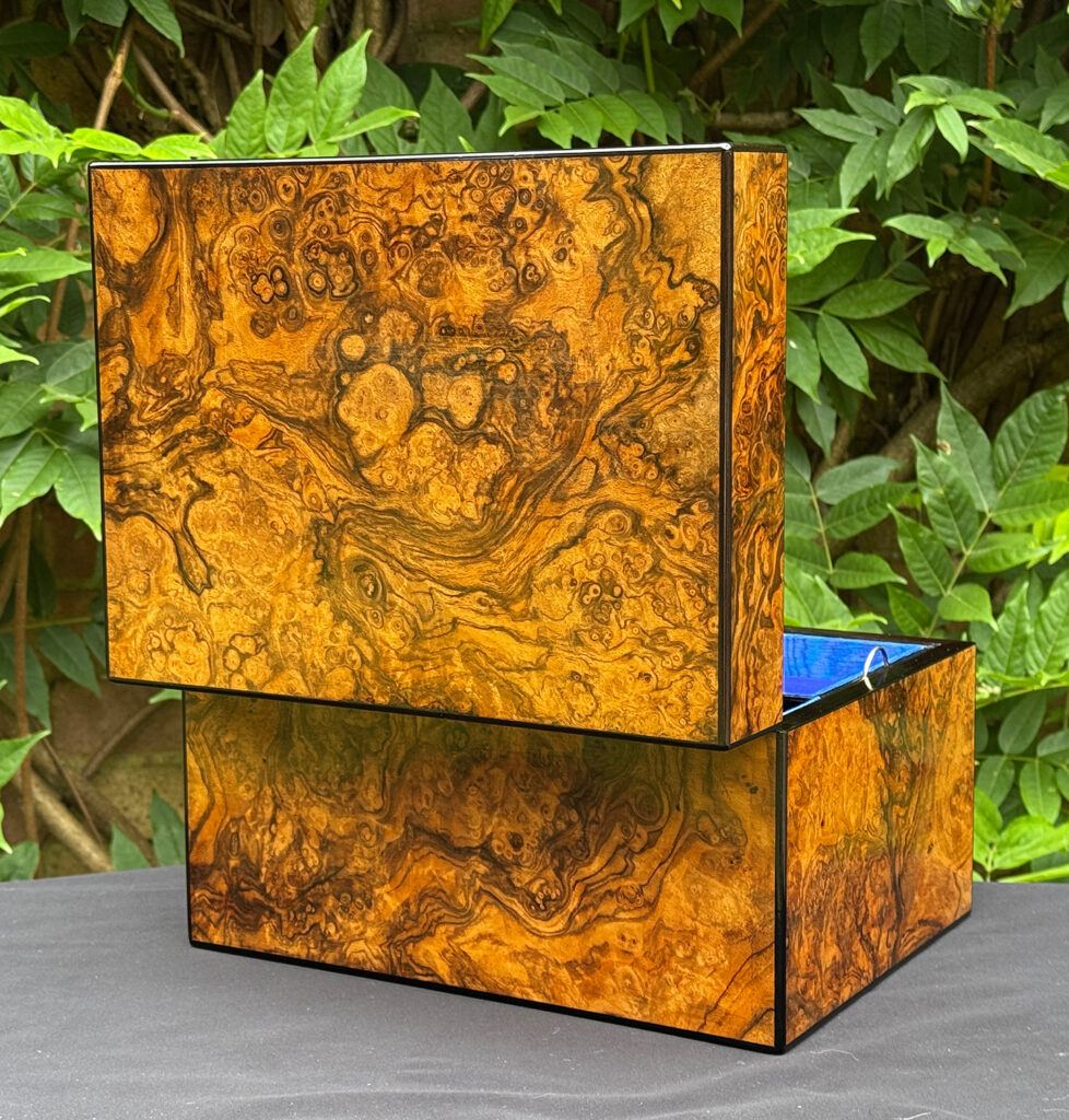 Rear opened view of an antique jewellery box in burr walnut, by George Betjemann & Sons.