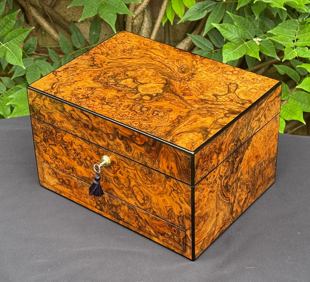 Overhead right view of an antique jewellery box in burr walnut, by George Betjemann & Sons.
