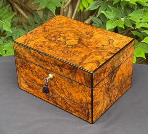 Overhead right view of an antique jewellery box in burr walnut, by George Betjemann & Sons.