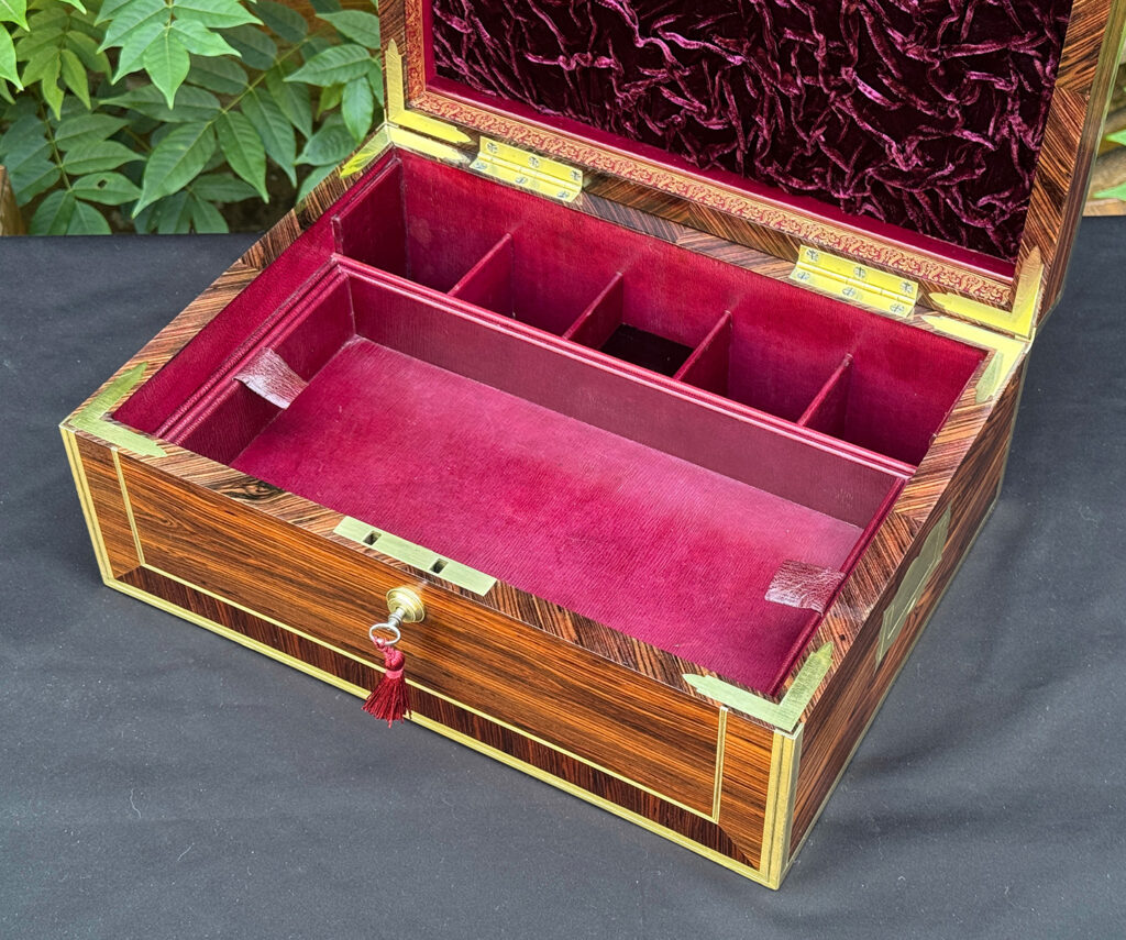 Closer interior view of an antique jewellery box in kingwood, by David Edwards, with lower tray in view.