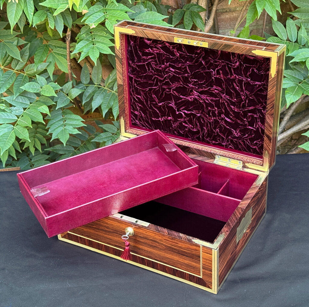 Front right interior view of an antique jewellery box in kingwood, by David Edwards, with bottom tray removed.