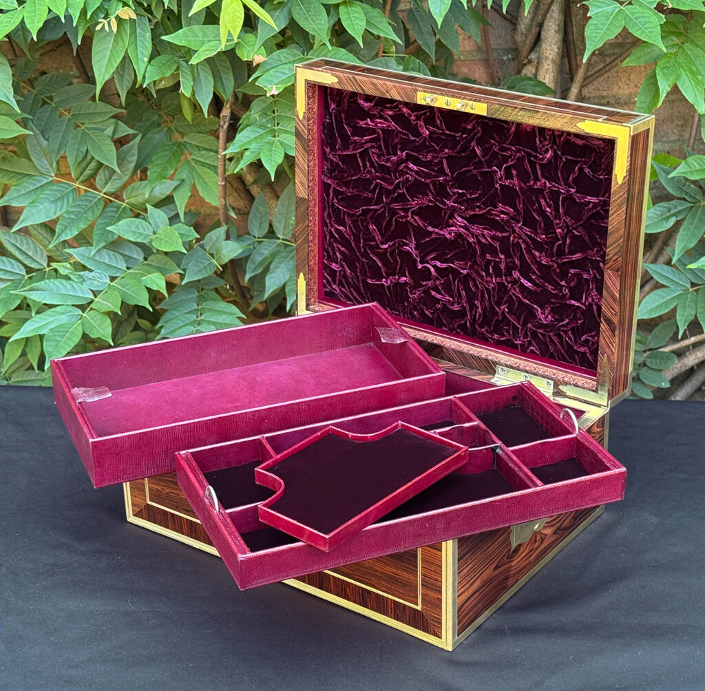 Front right interior view of an antique jewellery box in kingwood, by David Edwards, with all trays removed.