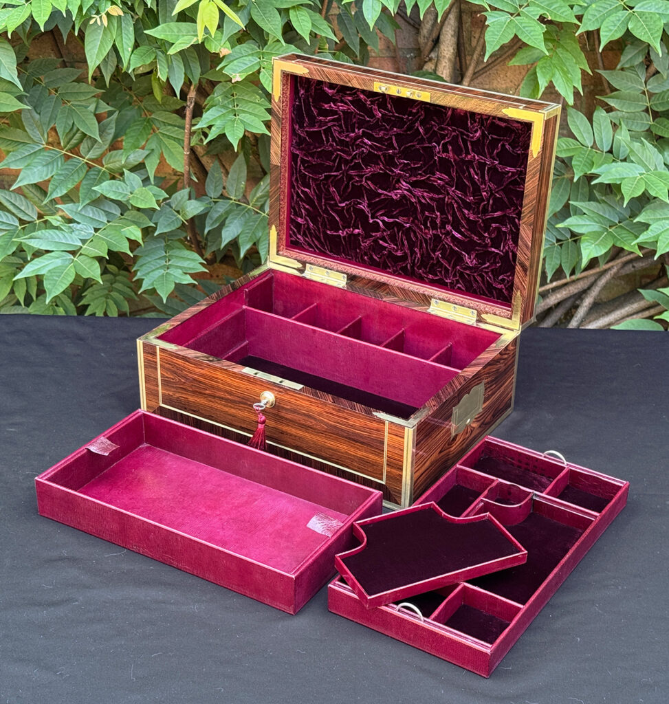 Front right interior view of an antique jewellery box in kingwood, by David Edwards, with all trays fully removed.