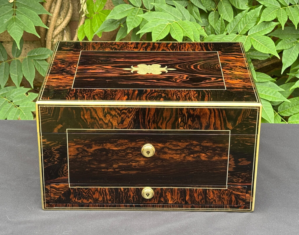 Front view of an antique jewellery box in calamander.