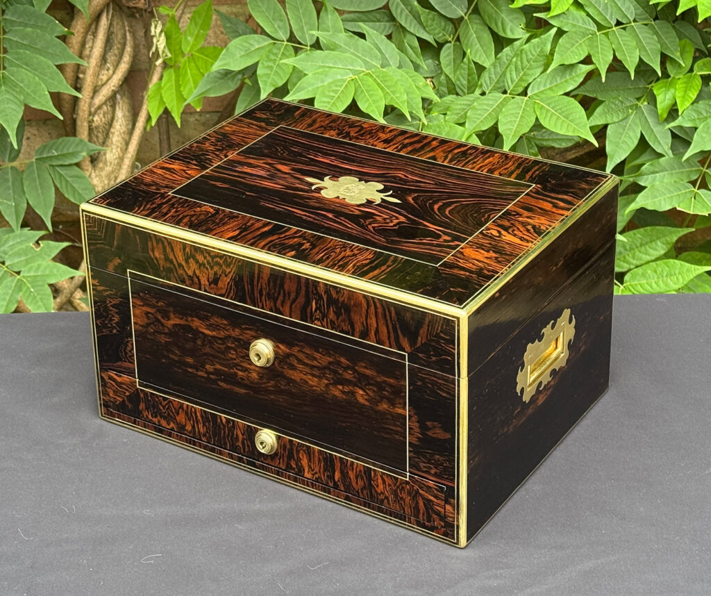 Front right view of an antique jewellery box in calamander.