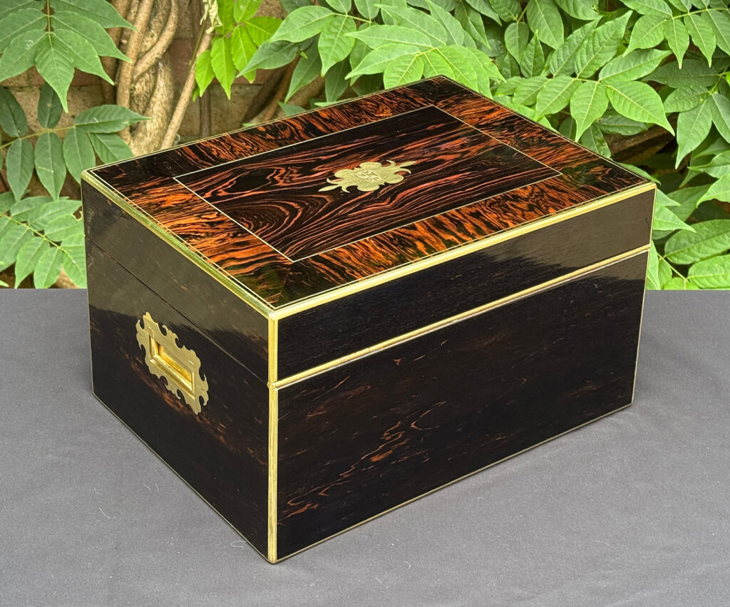 Rear right view of an antique jewellery box in calamander.