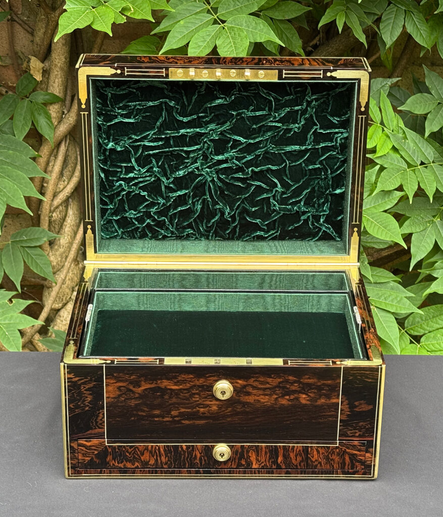 Front interior view of an antique jewellery box in calamander.