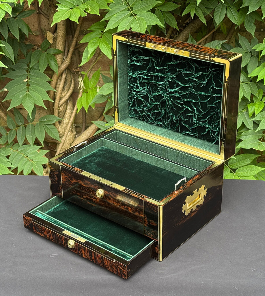 Front right interior view of an antique jewellery box in calamander.