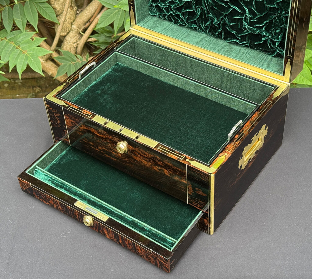 Closer interior view of an antique jewellery box in calamander.