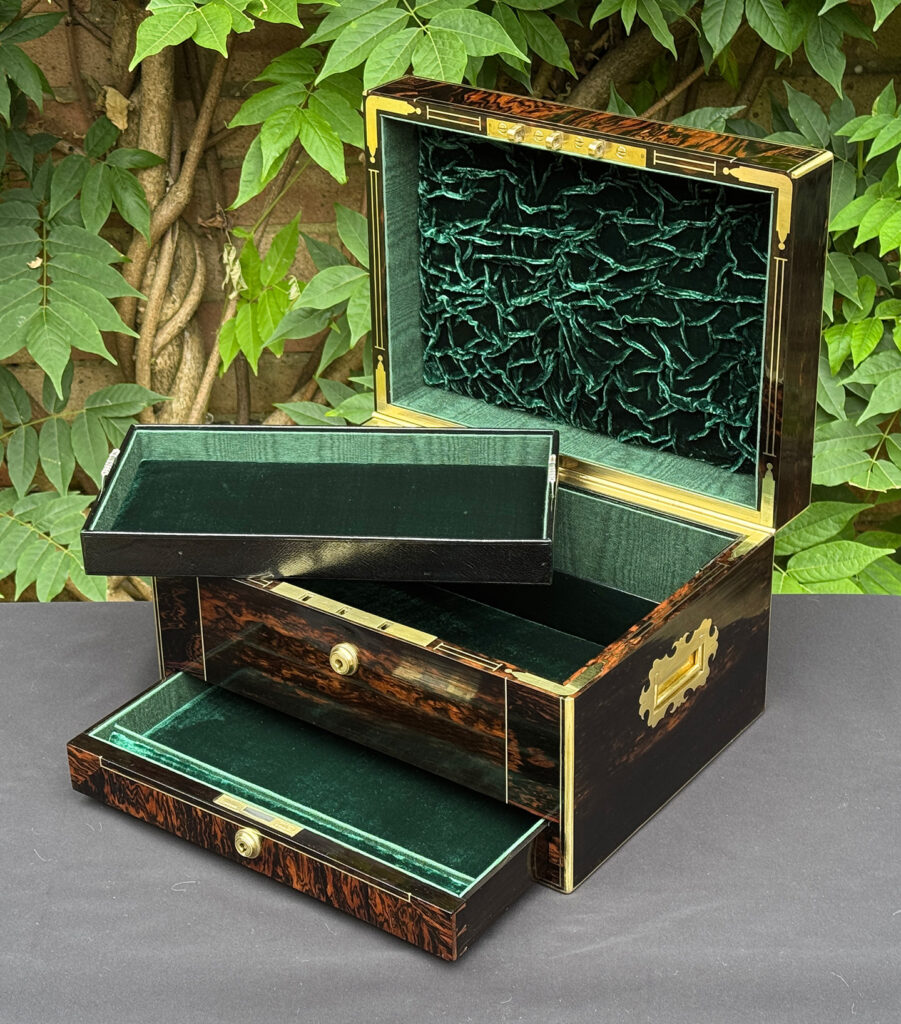 Front right interior view of an antique jewellery box in calamander, with tray removed.