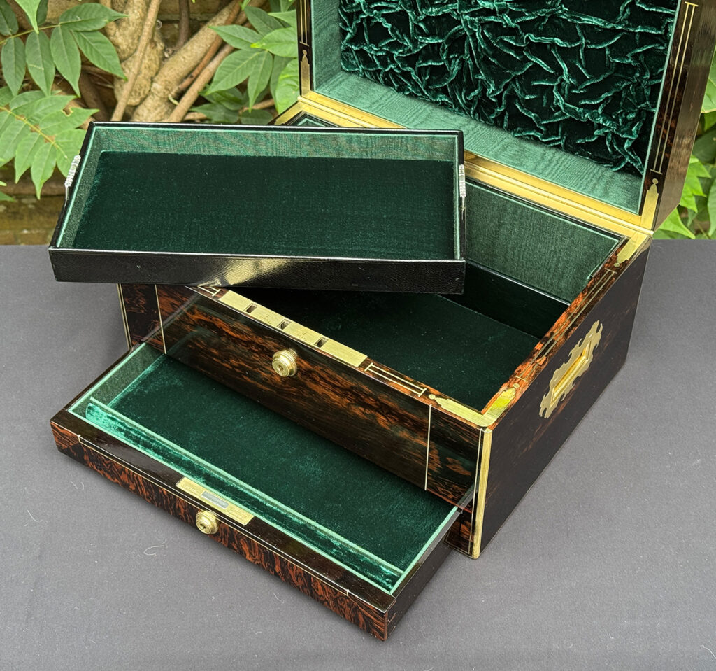 Closer interior view of an antique jewellery box in calamander, with tray removed.