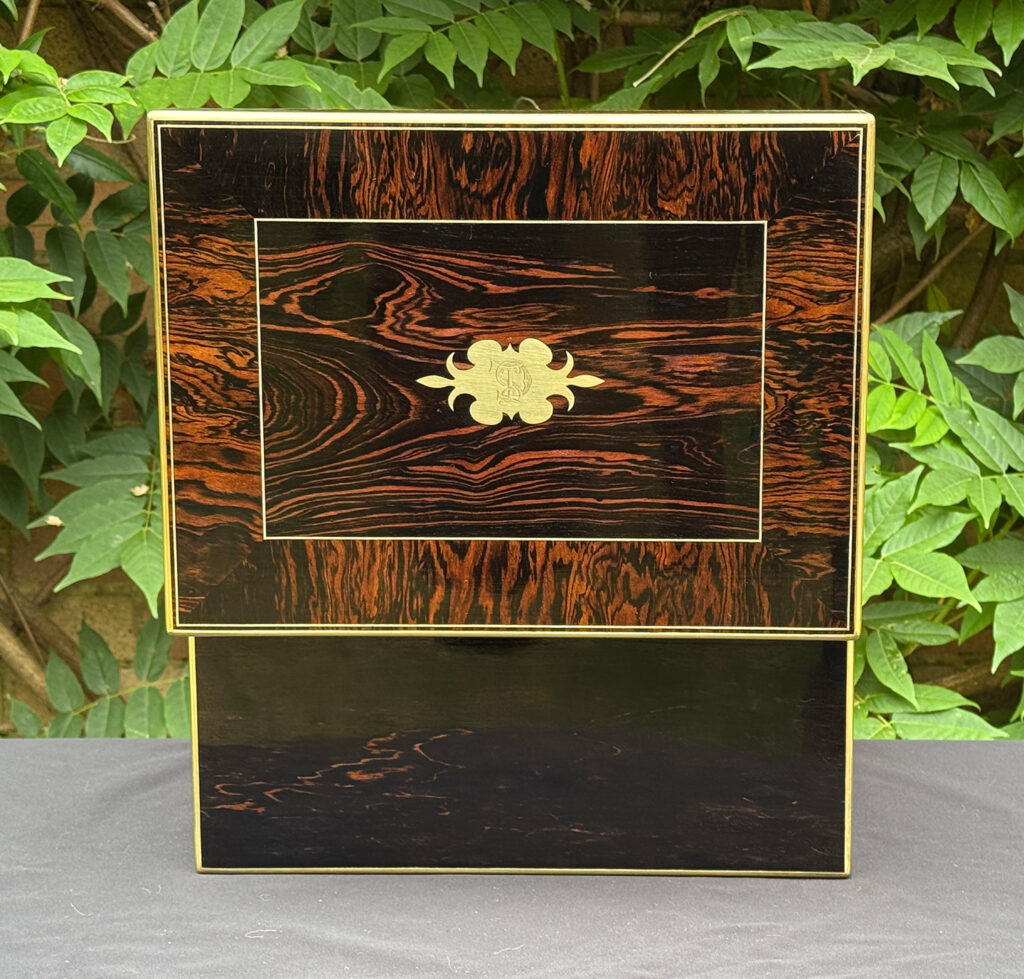 Rear opened view of an antique jewellery box in calamander.