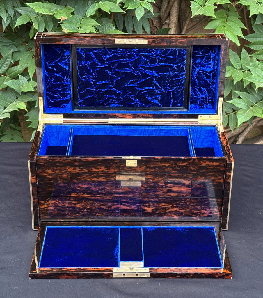 Front interior view of an antique jewellery box in coromandel, by William Lund, with front flap lowered.
