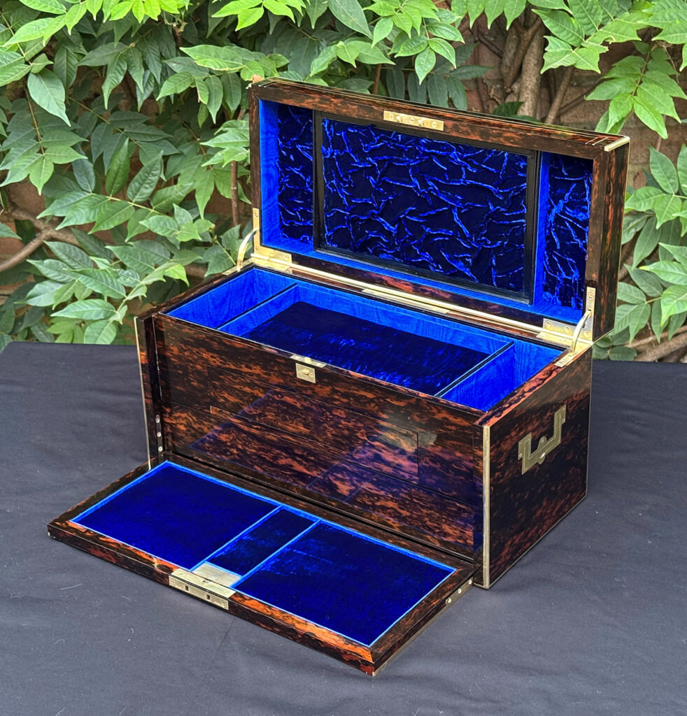 Front right interior view of an antique jewellery box in coromandel, by William Lund, with front flap lowered.
