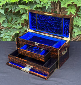 Front right interior view of an antique jewellery box in coromandel, by William Lund, with both concealed drawers opened.
