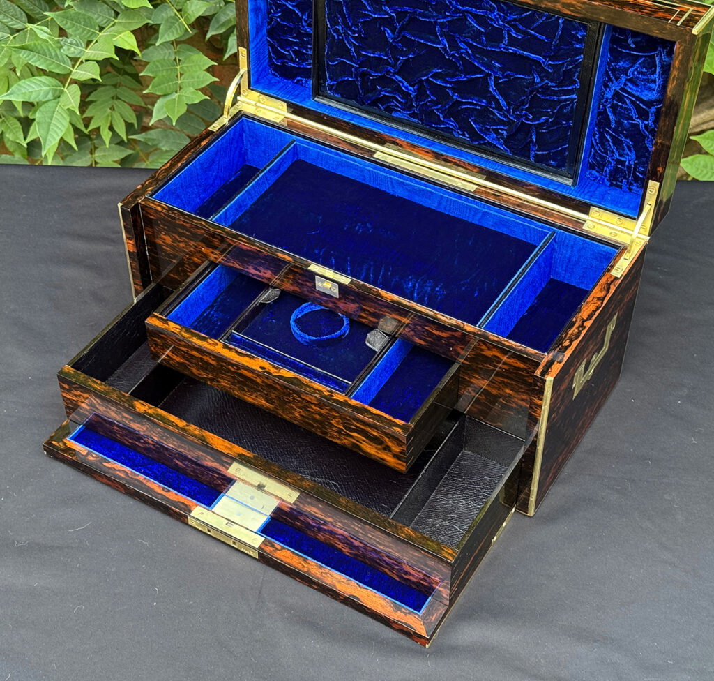 Closer interior view of an antique jewellery box in coromandel, by William Lund, with both concealed drawers opened.