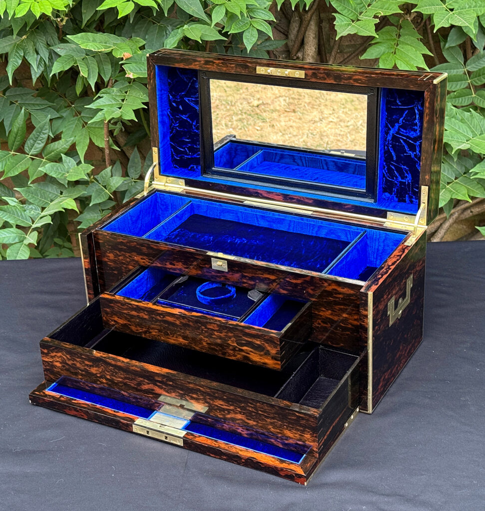 Front right interior view of an antique jewellery box in coromandel, by William Lund, with both concealed drawers opened and mirror on display.